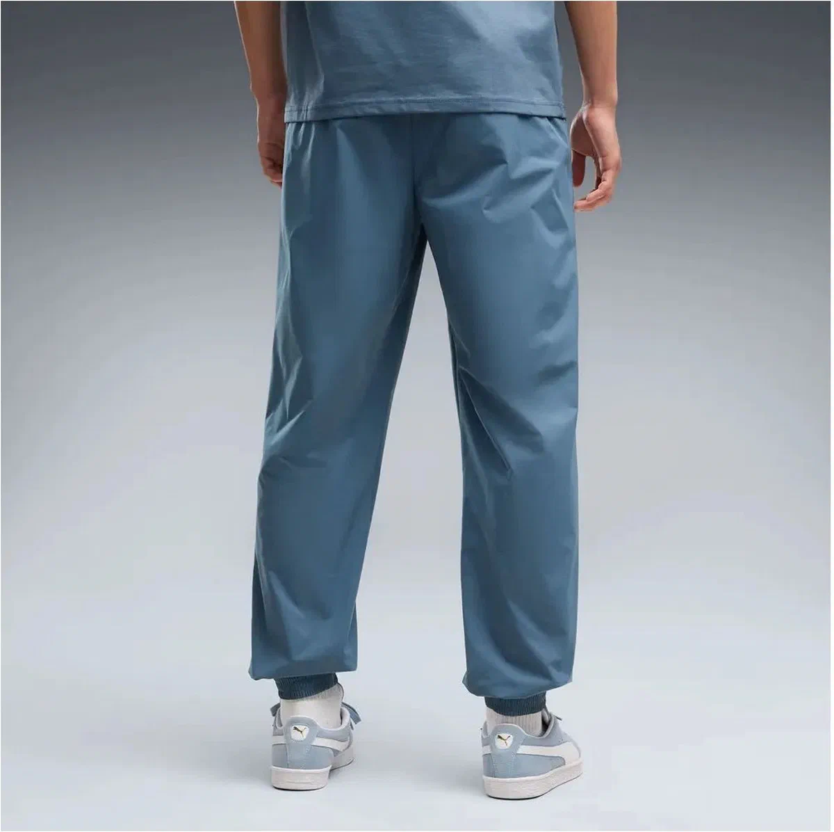 Pantalon tissé PUMATECH bleu ardoise de Manchester City porté, chevilles resserrées
