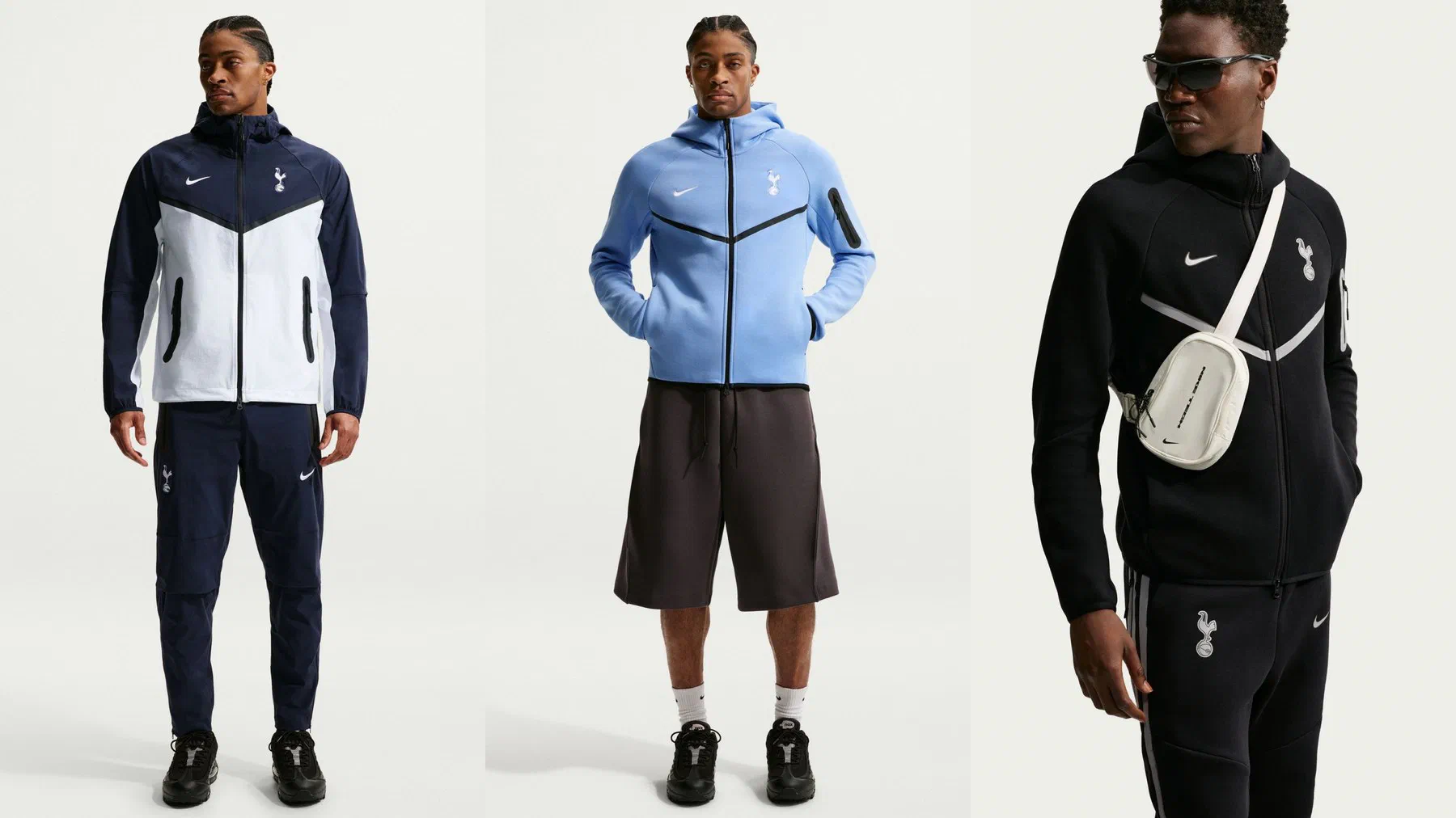 Veste Tech Woven Tottenham marine et blanche portée avec son pantalon marine, veste Tech Fleece bleu ciel et ensemble Tech Fleece noir à liserés gris